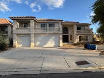 Two-story home featuring a double garage, balconies, and classic Mediterranean-style architecture at 9181 Ivory Beach Dr, Las Vegas, NV 89147