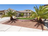 Charming single-story home featuring desert landscaping and mature palm trees at 9282 W Viking Rd, Las Vegas, NV 89147
