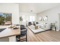 Bright living room featuring a plush sectional sofa, stylish decor, and natural light from a large window at 10301 Coal Creek Pl, Las Vegas, NV 89134