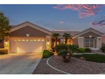 Charming single-story home featuring a two-car garage, desert landscaping, and a cozy front porch at 10832 Heritage Hills Dr, Las Vegas, NV 89134