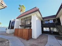 Charming two-story condo with a brown tile roof and a quaint fenced in front yard at 1405 Vegas Valley Dr # 380, Las Vegas, NV 89169