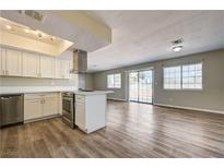 Bright kitchen featuring white cabinets, stainless steel appliances, and modern island at 1620 Yellow Rose St, Las Vegas, NV 89108