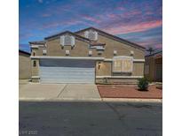Charming single-story home featuring a two-car garage, red rock landscaping, and a neutral stucco facade at 1644 Otto Merida Ave, Las Vegas, NV 89106