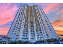 Stunning high-rise condo building with a sleek design and beautiful sunset backdrop at 200 W Sahara Ave # 603, Las Vegas, NV 89102