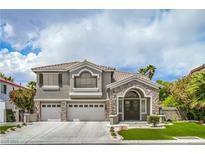 Charming two-story home featuring a stone-accented facade, three-car garage, and well-maintained landscaping at 2959 Azure Bay St, Las Vegas, NV 89117