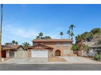 Charming two-story home featuring a spacious driveway and well-maintained yard, perfect for Gathering living at 4990 Spring Oak St, Las Vegas, NV 89120