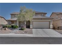 Charming two-story home with a well-maintained front yard and a two car garage on a clear, sunny day at 5912 Kit Cove Ct, Las Vegas, NV 89131