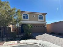 Two-story home featuring a two-car garage and low maintenance front yard with stone accents at 6093 Crown Palms Ave, Las Vegas, NV 89139