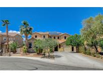 Charming two-story home featuring desert landscaping, mature trees, and a spacious driveway leading to a two-car garage at 6409 Sea Swallow St, North Las Vegas, NV 89084