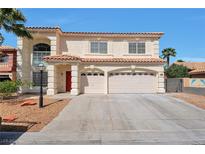 Charming two-story home featuring a stucco facade, a red tiled roof, and a spacious three-car garage at 6509 Alpine Winter Ct, Las Vegas, NV 89149