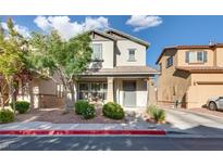 Charming two-story home featuring well-maintained landscaping and a welcoming front porch at 680 Moonlight Stroll St, Henderson, NV 89002