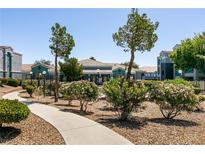 Inviting clubhouse exterior with manicured landscaping and a welcoming walkway at 6955 N Durango Dr # 2081, Las Vegas, NV 89149
