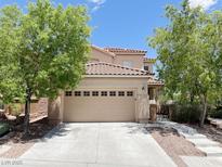 Charming two-story home featuring a two-car garage and mature landscaping at 740 White Grotto St, Las Vegas, NV 89138
