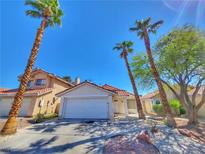 Charming single-story home with a well-manicured yard and mature palm trees under a bright blue sky at 7614 Isley Ave, Las Vegas, NV 89147