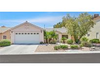 Charming single-story home with a well-maintained lawn and a two car garage at 7645 Falconwing Ave, Las Vegas, NV 89131