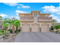 Impressive three-car garage home featuring beautiful balconies, stone accents, and manicured landscaping at 807 Canyon Greens Dr, Las Vegas, NV 89144