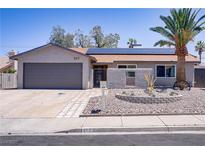 Charming single-story home featuring desert landscaping, a two-car garage, and solar panels at 823 Cherry Dr, Henderson, NV 89002