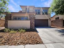 Inviting two-story home with a well-manicured front yard and an attached two-car garage at 9319 Bronze River Ave, Las Vegas, NV 89149