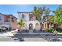 Two-story home with desert landscaping, a tile roof, and an inviting entryway at 10345 Howling Coyote Ave, Las Vegas, NV 89135