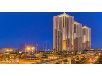 Modern luxury high-rise condominiums with lighted spires overlooking the city skyline at dusk at 125 E Harmon Ave # 717, Las Vegas, NV 89109