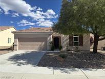 Charming single-story home featuring a two-car garage and inviting front yard landscaping at 2224 Waterton Rivers Dr, Henderson, NV 89044