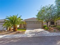 Charming single-story home with a well-manicured lawn, desert landscaping, and a two-car garage at 2558 Divine Sky Dr, Henderson, NV 89044