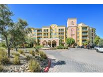Beautiful condo complex with arched entry, water feature, mature landscaping, and ample parking at 30 Strada Di Villaggio # 306, Henderson, NV 89011