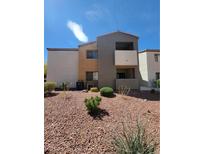 A well-kept exterior view of the condo with desert landscaping on a sunny day at 3151 Soaring Gulls Dr # 2101, Las Vegas, NV 89128