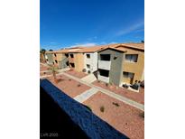 Inviting exterior view of condo with colorful landscaping, walkways, and ample parking at 3151 Soaring Gulls Dr # 2101, Las Vegas, NV 89128
