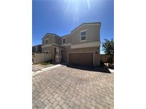Charming two-story home with a two-car garage and beautifully paved driveway at 369 Stone Fly Rd, North Las Vegas, NV 89032