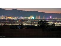 Stunning Las Vegas skyline view at night with mountains in the background, showcasing city lights at 392 Waterwheel Falls Dr, Henderson, NV 89015