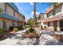Townhouse exteriors feature desert landscaping and concrete walkways for easy access to each unit at 4000 Visby Ln, Las Vegas, NV 89119