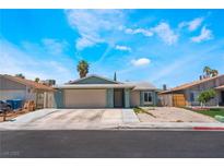 Inviting single-story home featuring a spacious driveway and a well-maintained front yard landscape at 508 Purcell Dr, Las Vegas, NV 89107