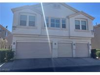 Two-story home with three-car garage and well-maintained landscaping in a residential neighborhood at 9333 Leaping Deer Pl # 103, Las Vegas, NV 89178