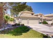 Inviting front exterior with a well-maintained lawn and a spacious two-car garage at 9552 Wooden Pier Way, Las Vegas, NV 89117