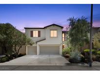 Two-story home featuring a spacious two car garage, neutral paint, and tasteful landscaping at 9872 Chief Sky St, Las Vegas, NV 89178