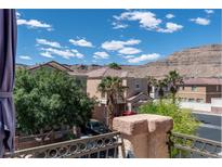 View of the home's exterior, showcasing the desert landscaping and mountain views at 9962 Derby Creek Way, Las Vegas, NV 89148