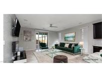 A living room with an emerald green sofa, glass coffee table, and modern decor elements at 1015 Solana Crest St, Henderson, NV 89052
