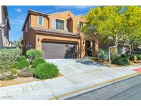 Two-story home featuring a two car garage, manicured landscaping, and a 'for sale' sign in the front yard at 11014 Great Sioux Rd, Las Vegas, NV 89179
