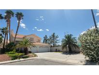 Charming two-story home features a three-car garage, desert landscaping, and a tile roof at 1211 Silver Knoll Ave, Las Vegas, NV 89123