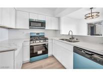 Bright kitchen features new appliances, marble countertops, and white cabinets at 1424 Santa Anita Dr # D, Las Vegas, NV 89119
