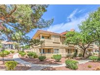 Charming multi-Gathering home featuring lush landscaping, mature trees, and a well-maintained walkway at 1557 Lake Placid Ter # 1557, Henderson, NV 89014