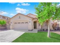 Inviting single-story home featuring a well-manicured lawn and two-car garage under a bright blue sky at 177 Rocky Star St, Henderson, NV 89012