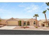 Single-story home with desert landscaping, two palm trees, and a two-car garage at 2069 Colvin Run Dr, Henderson, NV 89052