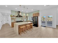 Bright kitchen features an island with seating, pendant lights, and modern appliances at 2160 Pueblo Cir, Las Vegas, NV 89169