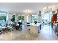 Open-concept living space with modern kitchen, dining area, and comfortable lounge, featuring large windows and sleek finishes at 2747 Paradise Rd # 206, Las Vegas, NV 89109