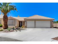 Charming single-story home featuring a two-car garage, desert landscaping, and a beautiful palm tree at 2848 Skowhegan Dr, Henderson, NV 89074