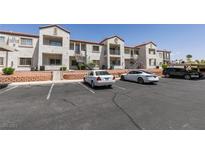 Exterior view of a two-story apartment complex with parking lot and landscaping at 3318 N Decatur Blvd # 2110, Las Vegas, NV 89130