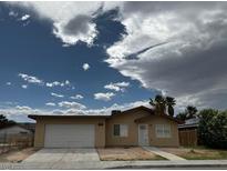 Single story home with a two car garage and low maintenance landscaping at 4189 Studio St, Las Vegas, NV 89115