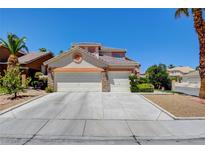 Two-story home with a three-car garage, desert landscaping, and neutral-toned stucco and trim at 4835 Willow Glen Dr, Las Vegas, NV 89147